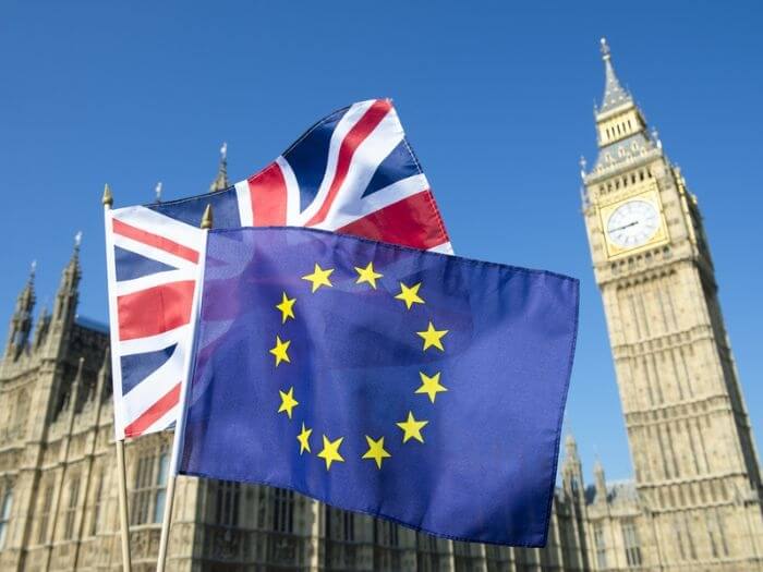 The UK and EU flags, waved together in front of Big Ben in London.