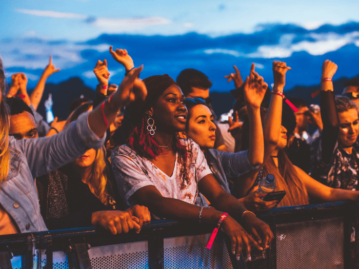 A crowd of young people at a festival.